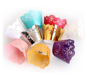 Laser cut lace cupcake wrappers in various metallic and pastel colors for party decor