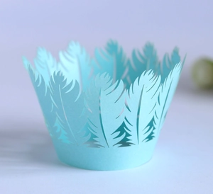 Detailed laser-cut light blue cupcake wrapper with elegant feather pattern design