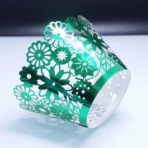 Intricate laser-cut green metallic floral cupcake wrappers for wedding party decoration