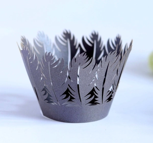 Detail view of dark grey cupcake liner with laser-cut feather lace pattern