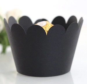 Macro shot of laser-cut black matte paper cupcake wrappers with wavy petal-edge design