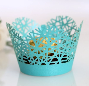 Laser cut light blue snowflake cupcake wrappers for festive wedding cake decorations