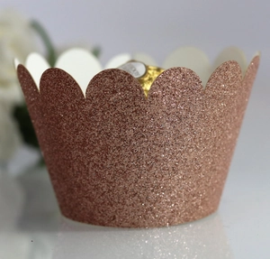 Detail of rose gold glitter cupcake wrappers with scalloped edges for festive decoration