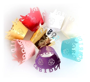 Laser cut bride and groom cupcake wrappers in various colors for wedding decoration