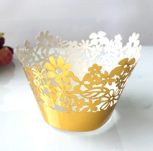 Detailed laser-cut gold floral cupcake wrapper with intricate metallic hollow patterns