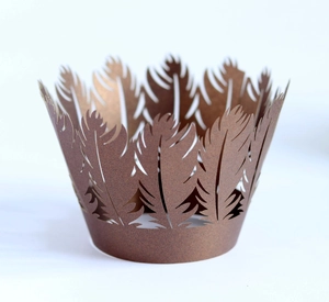 Macro detail of laser-cut pink feather pattern cupcake wrappers for baking decorations