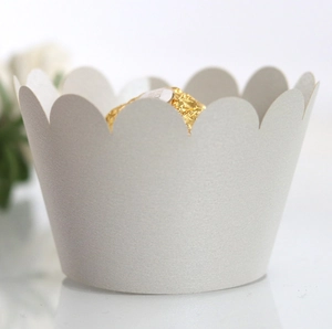 Macro shot of white scalloped cupcake wrapper with elegant matte texture finish