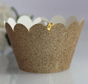 Detail of champagne gold glitter cupcake wrappers with decorative wavy scalloped edges