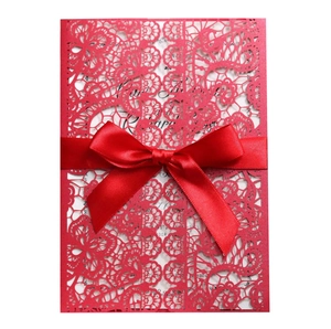 Elegant red laser-cut floral invitation set with silk ribbon and white insert card