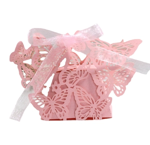 Pink laser-cut butterfly wedding favor box with translucent white ribbon closure