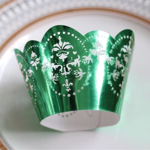 Green metallic laser-cut cupcake wrappers with fleur-de-lis pattern for party decor