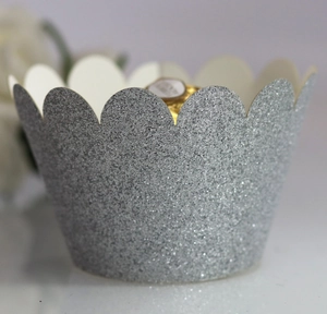 Close-up of silver glitter cupcake wrapper with elegant scalloped edges for desserts