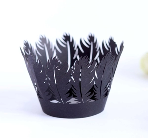 Detail showing laser-cut black paper cupcake liners with delicate feather crown pattern