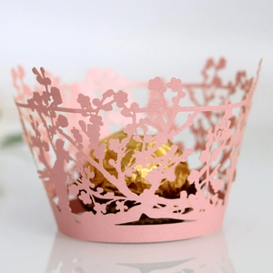 Pink laser-cut cupcake wrappers with floral hollow design for wedding party decorations