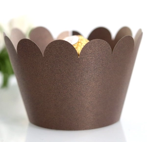 Close-up of laser cut dark brown cupcake wrapper with wavy pearl finish edge