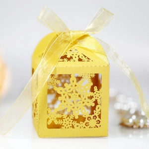 Elegant yellow laser-cut snowflake gift box with matching organza ribbon for parties