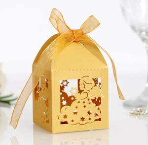 Detailed laser-cut angel candy box in golden pearlescent paper with organza ribbon