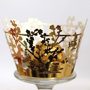 Laser cut golden cupcake wrappers with floral silhouette and metallic finish for parties