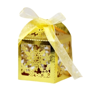 Elegant gold hollow gift box with snowflake laser cut patterns and a yellow organza ribbon