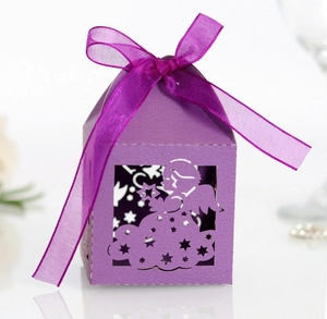Detail of purple laser-cut gift box with angel and star patterns and organza ribbon