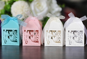 Detail of laser-cut hollow candy boxes with Mr & Mrs groom and bride silhouette