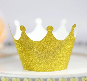 Close-up of golden glitter crown cupcake topper with sparkling metallic textured finish