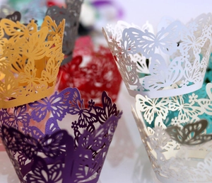 Macro detail of laser-cut butterfly cupcake wrappers in various pearlescent colors