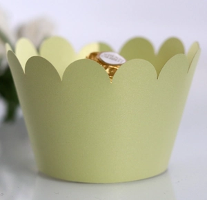 Detail of light green scalloped cupcake wrapper with a subtle pearlescent finish
