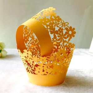 Intricate laser-cut yellow flower cupcake wrapper with handle for party dessert decor