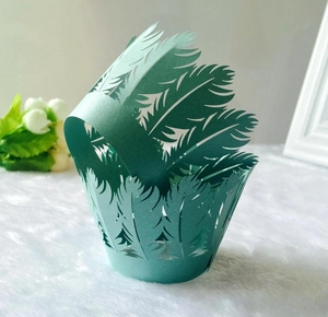 Detailed laser-cut tiffany blue feather pattern cupcake wrappers for elegant dessert display