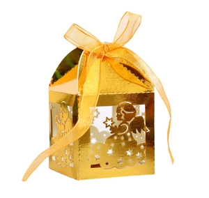 Detail of laser cut angel favor box in gold finish with elegant yellow organza ribbon