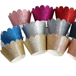 Glittery scalloped cupcake liners in multiple colors for festive cake decoration