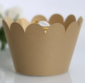 Close-up of golden scalloped cupcake wrapper with premium metallic pearlescent texture
