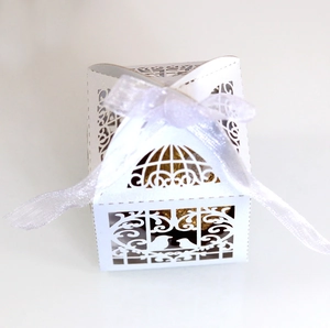 Detailed laser-cut lovebird candy box with white ribbon and chocolate interior
