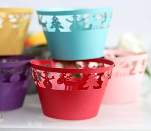 Laser-cut Christmas tree and snowman cupcake wrappers in vibrant holiday colors