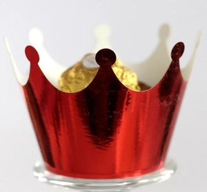 Detail of red metallic crown cupcake wrapper with golden chocolate decorative accent
