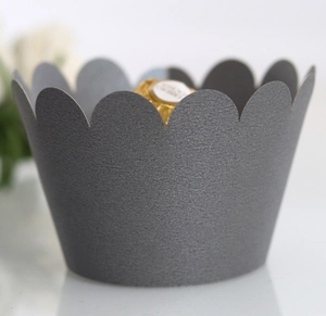 Detail of dark grey cupcake wrapper with metallic shimmer and elegant wavy edges