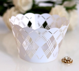 Detailed laser-cut white cupcake wrappers with elegant lace pattern for party decoration