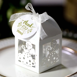 Detail of white laser-cut angel gift box with stars and a Thank You ribbon tag