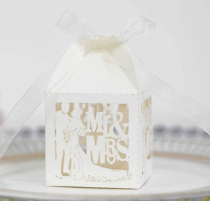 Detailed laser-cut wedding favor box with Mr & Mrs silhouette and white ribbon bow