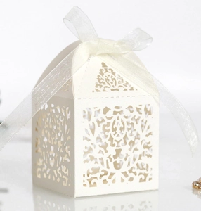 Detailed laser-cut vine patterns on cream white wedding favor box with organza ribbon
