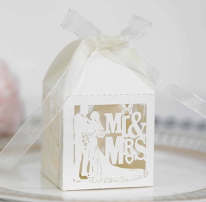 Detailed laser-cut white wedding favor box with Mr & Mrs silhouette and white ribbon bow