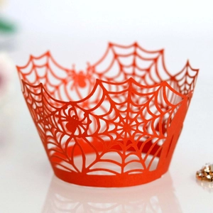 Red laser-cut Halloween cupcake wrappers with intricate hollow spider web patterns