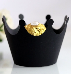 Detail shot of a matte black crown-shaped cupcake liner holding a chocolate truffle