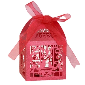 Détail de la boîte cadeau ajourée rouge avec motif oiseau et ruban en soie