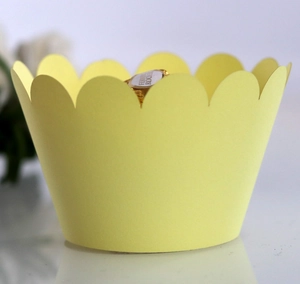 Macro detail of yellow scalloped edge cupcake wrappers for elegant dessert decoration