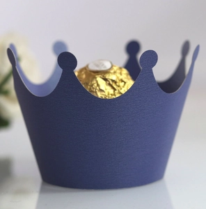 Detail of navy blue crown laser cut paper cupcake liner with textured finish