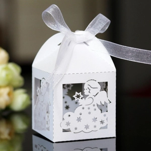 Laser-cut white baby shower candy box featuring angel and star patterns with ribbon