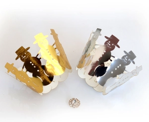 Close-up of gold and silver laser-cut snowman cupcake liners with rhinestone detail