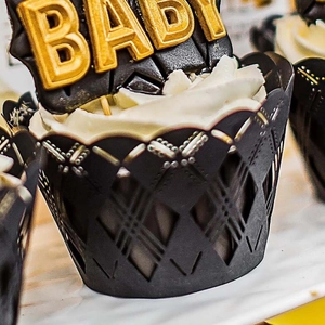 Intricate laser-cut black cupcake wrapper with a 3D golden BABY cake topper set